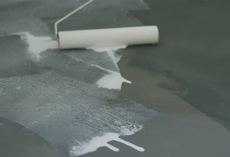 worker sealing concrete floor