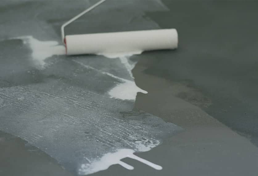worker sealing concrete floor