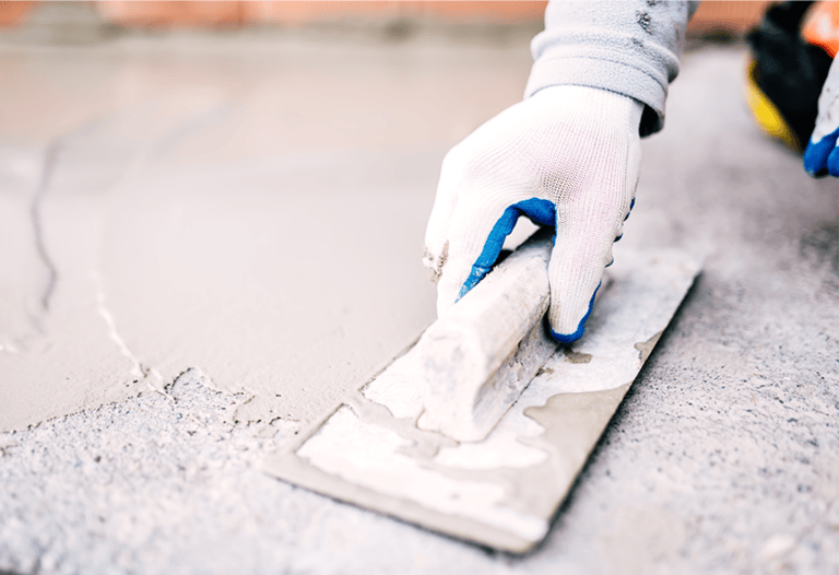 person repairing cracks in concrete