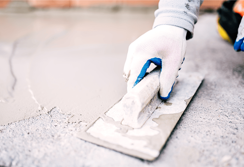 person repairing cracks in concrete