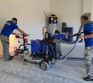 MACH ONE® employees grinding flooring