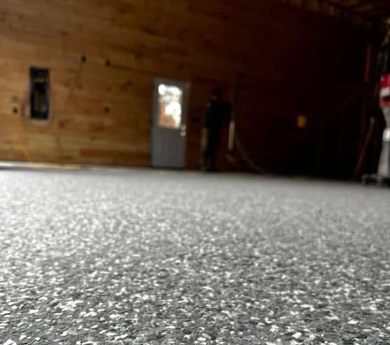 close-up of Stoney Creek Epoxy Flake Flooring for homeowner barn