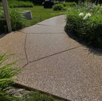 after portrait of homeowner side walk with new epoxy flooring