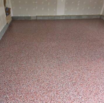 red garage floor with new epoxy flake flooring