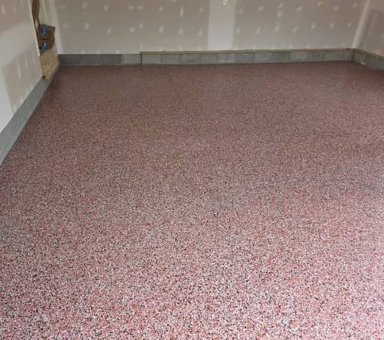 red garage floor with new epoxy flake flooring