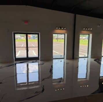 Boutique Owner with solid epoxy flooring freshly installed