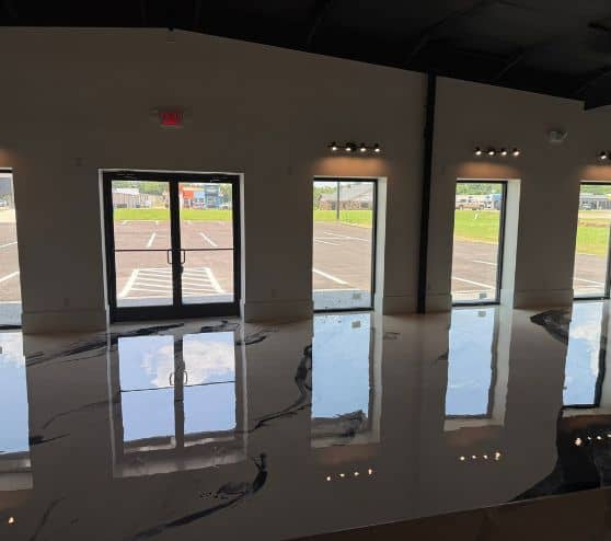 Boutique Owner with solid epoxy flooring freshly installed