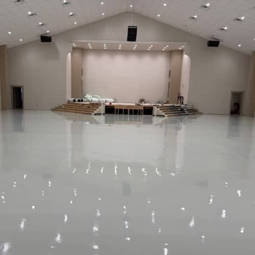 lights reflecting off epoxy floors inside church