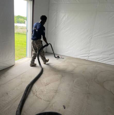 employee working on epoxy flake flooring project in Burleson, TX