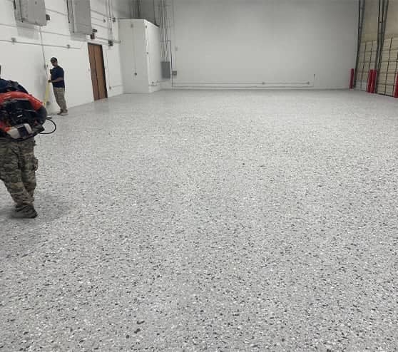 employees working on new epoxy flooring for warehouse