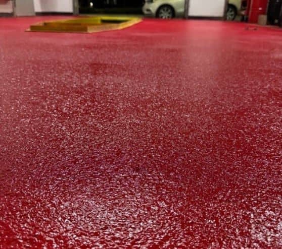 close-up of red solid epoxy flake flooring