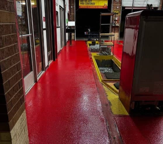 red solid epoxy flooring close up for Take 5 Oil Change