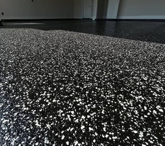 close-up of black and white epoxy flake flooring installed for homeowner