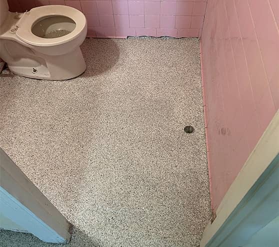 bathroom floor with new epoxy flake flooring for church