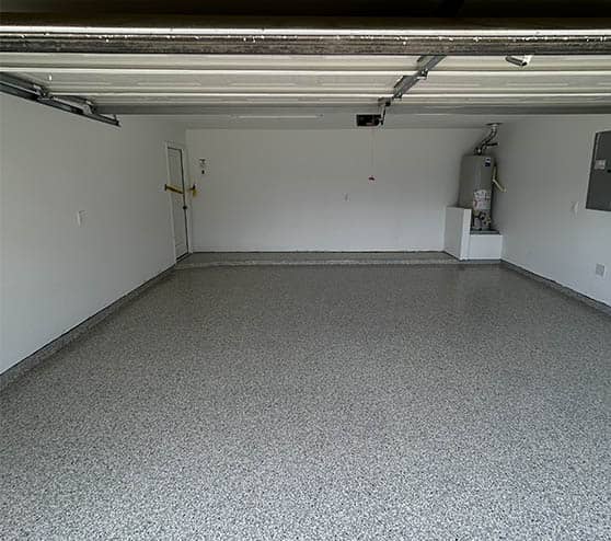 homeowner garage with freshly poured epoxy flake flooring