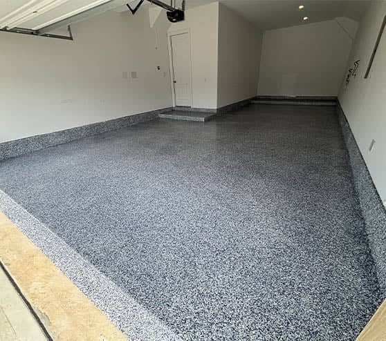 homeowner garage with freshly poured epoxy flake flooring