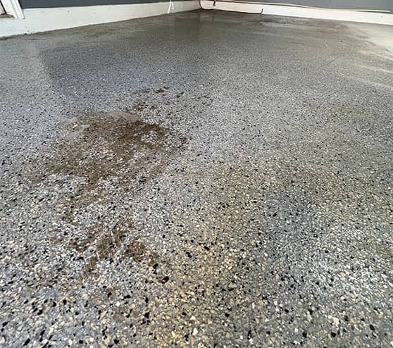 old garage epoxy flooring before new flooring installed