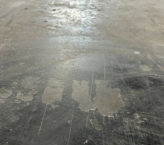 close-up of chipped concrete flooring