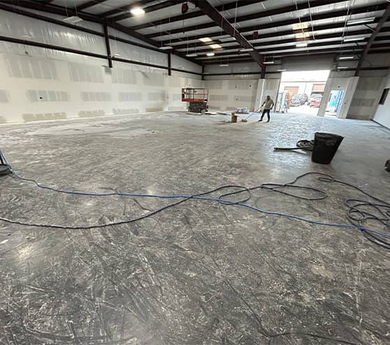 Kenneth's Car Care warehouse with flooring getting scraped up