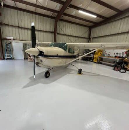 front view of airplane parked on new solid epoxy flooring