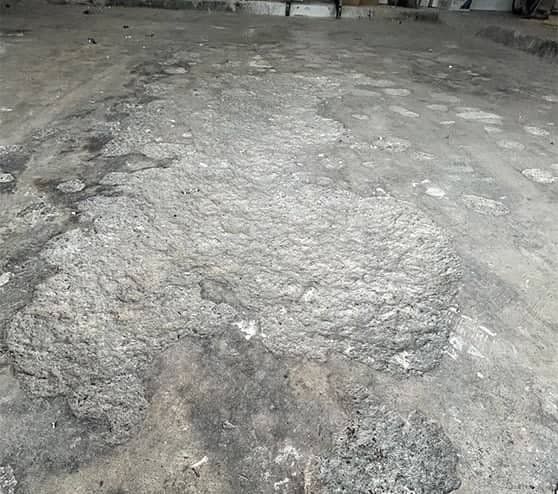 garage floor with damage from fire