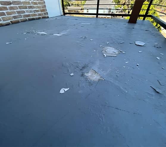 close-up of chipped concrete on balcony flooring