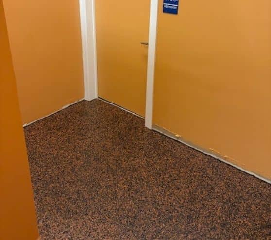 commercial building hallway with new custom epoxy flake flooring installed