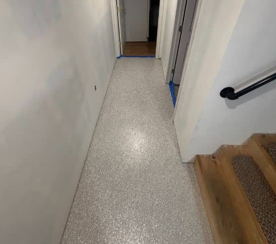 close-up of custom epoxy flake flooring for homeowner basement hallway