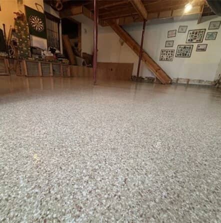 close-up of tan epoxy flake flooring installed for homeowner basement