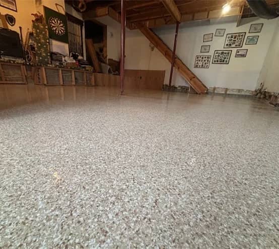 close-up of tan epoxy flake flooring installed for homeowner basement