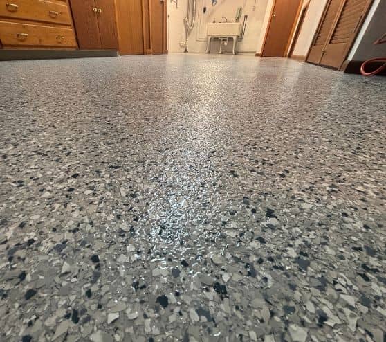close-up of tidal wave epoxy flake flooring installed for homeowner