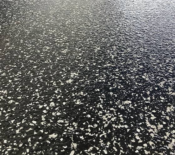 close-up of raven epoxy flake flooring