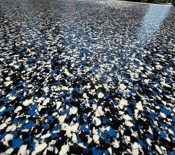 close-up of black and blue epoxy flake flooring for homeowner garage
