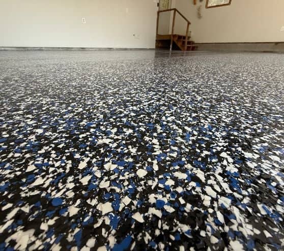 clsoe-up of freshly poured epoxy flake flooring for homeowner garage close-up