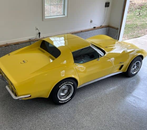 yellow corvette sitting in homeowner garage