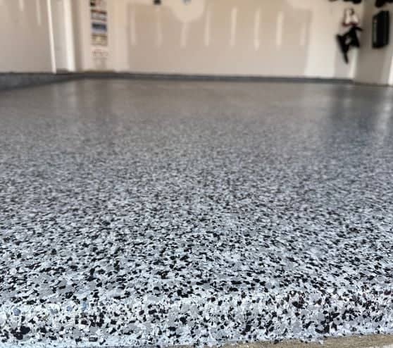 front view close-up of graphite epoxy flake flooring installed for homeowner garage