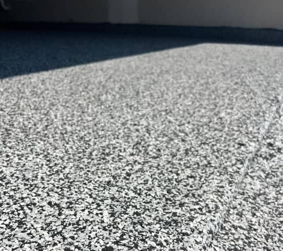 close-up of graphite epoxy flake flooring freshly installed for homeowner garage