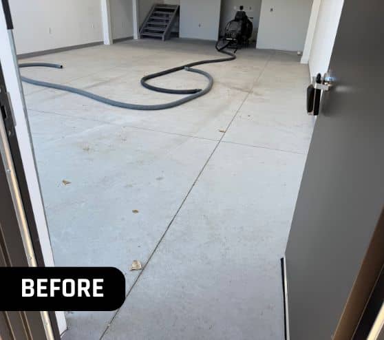 old concrete flooring in homeowner garage before new flooring installed