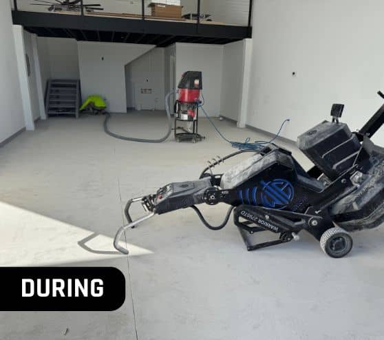 during portrait of homeowner garage with machinery on flooring