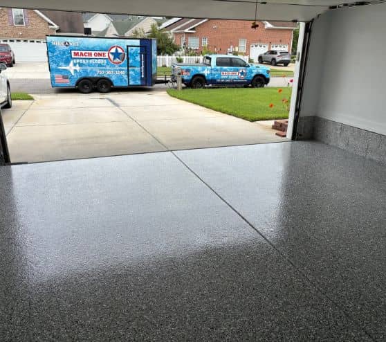homeowner garage with new grey epoxy flake flooring installed