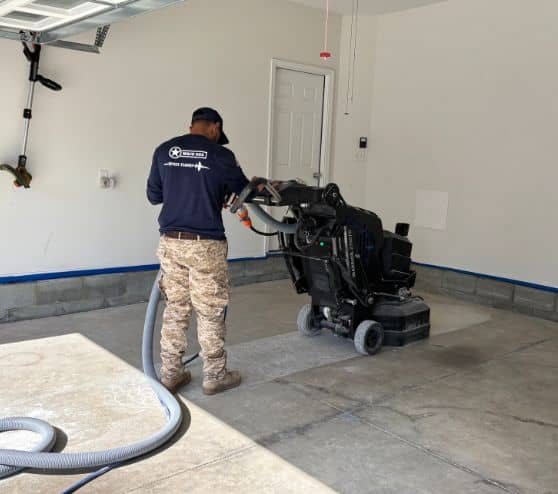 MACH ONE® employee grinding concrete floor