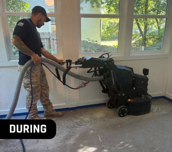 MACH ONE® employee grinding old flooring using big machine
