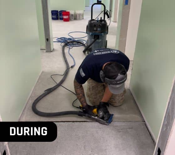 mach one® employee grinding old flooring insid of Lucky Pups Pet Wash