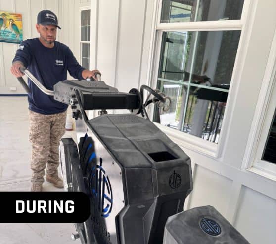 close-up of MACH ONE® employee using machine while installing new flooring