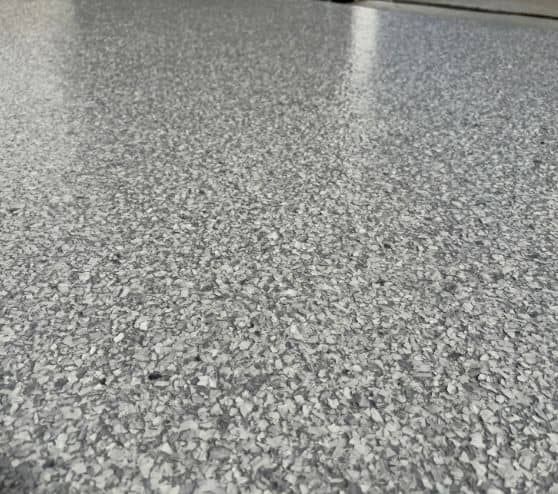 close-up of Schist Epoxy Flake Flooring for homeowner garage