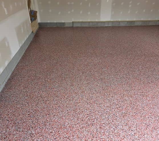 red garage floor with new epoxy flake flooring