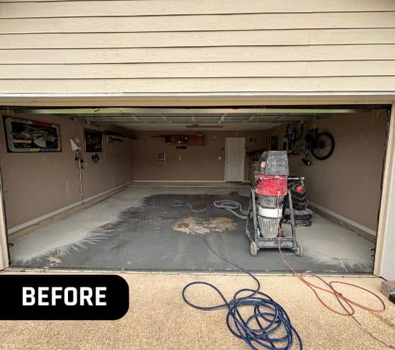 front view of homeowner garage with old chipped flooring before portrait