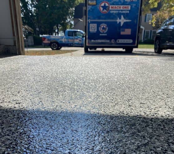 close-up of whisper grey epoxy flake flooring installed for homeowner garage