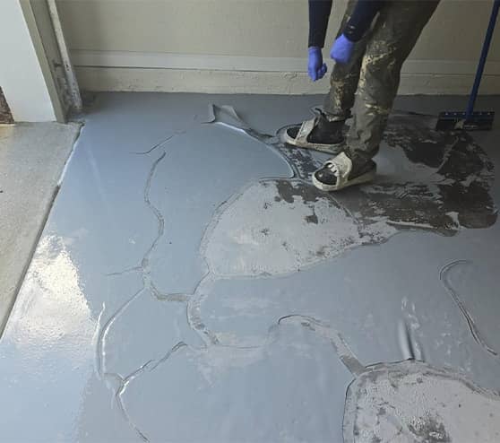 close-up of mach one employee smoothing concrete floor
