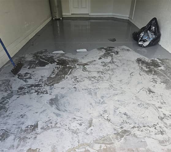 garage floor in the process of epoxy flooring